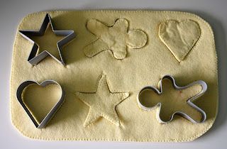 The cookie dough, cookie cutouts and cookie cutters