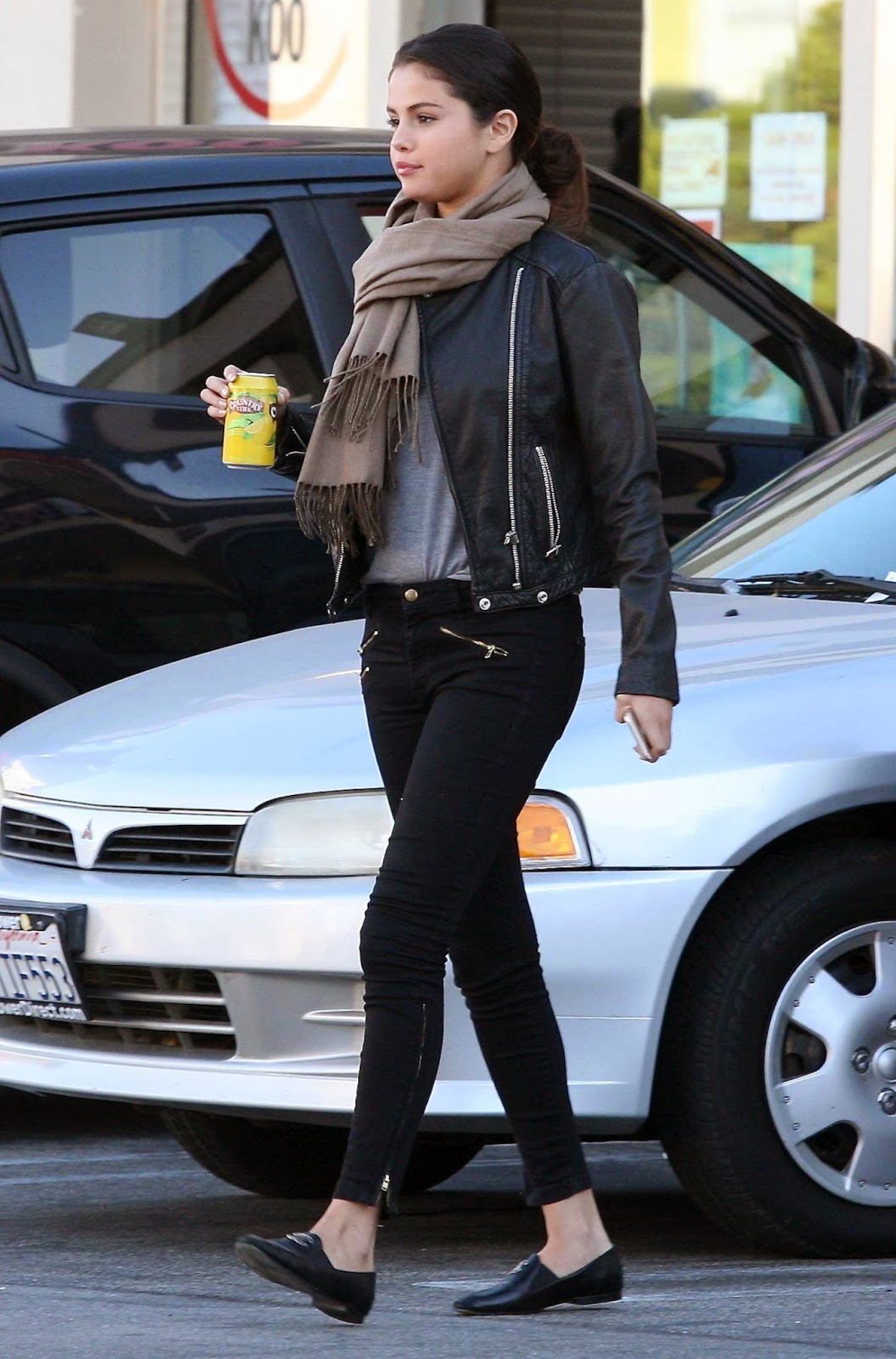 Selena Gomez in skinny jeans and leather jacket out and about in Studio