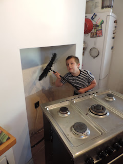 bare plasterwork for painting boy with chimney sweeps brush