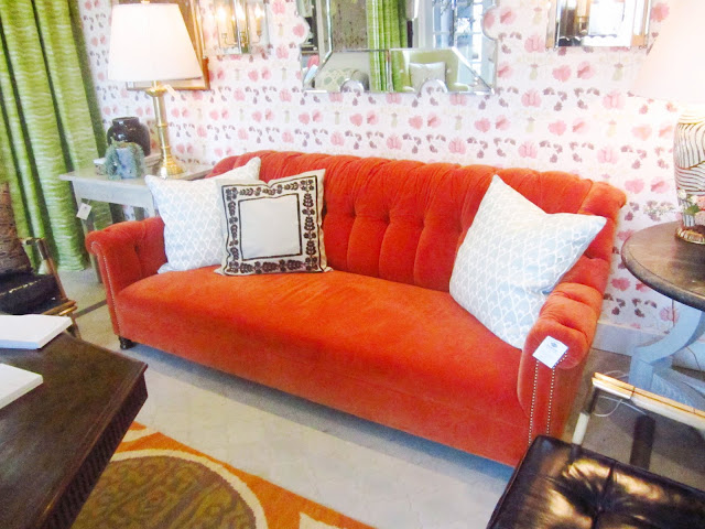 burnt orange velvet sofa with nail head trim with white accent pillows