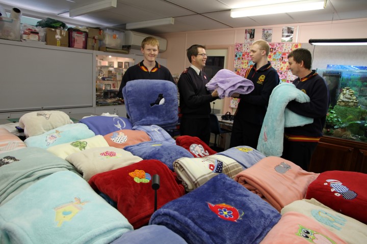Senior students embroider blankets for the homeless with the Salvation Army.