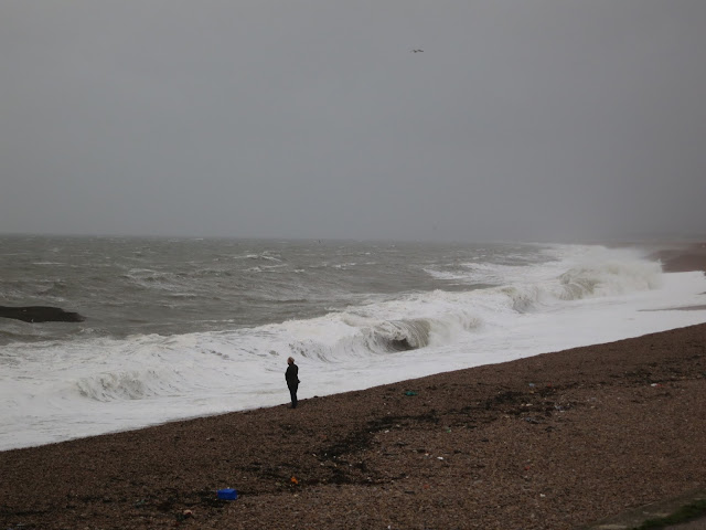 Man on Chesil Beach looks out to sea.