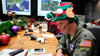 An Air Force Lt. takes a phone call from a child in Florida at the Santa Tracking Operations Center at Peterson Air Force Base near Colorado Springs, Dec. 24, 2010 file photo (Ed Andrieski/AP Photo)