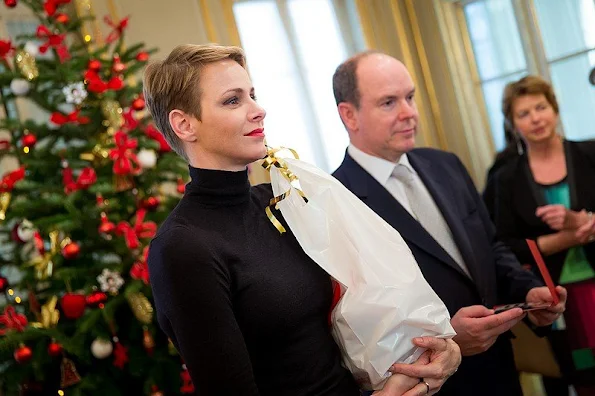 Prince Albert and princess Charlene of Monaco presented gifts to old people and children at "Red Cross" Monaco branch