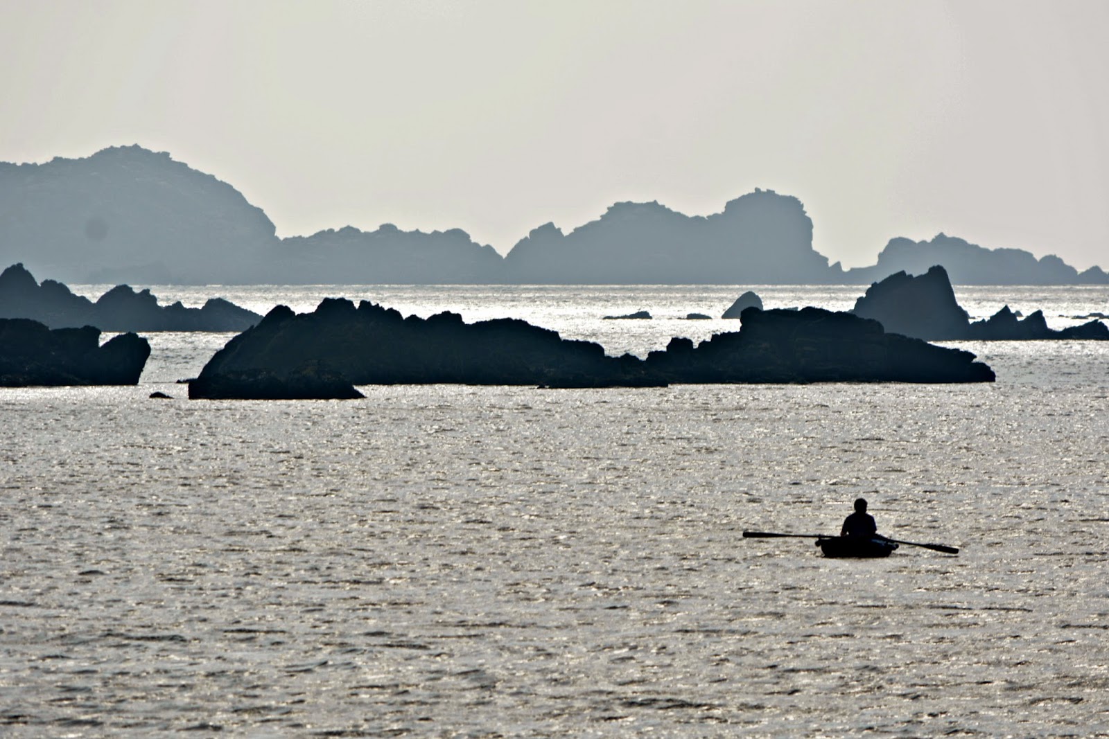 Man in a rowing boat Isles of Scilly