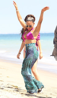 Christina Milian dancing at  a beach in Malibu in pink bikini top and colorful pants