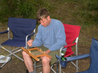 Caning canoe seats by the camp fire