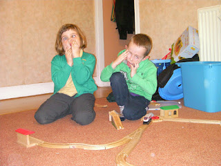 kids wooden train track pulling faces