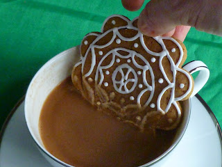 dipping gingerbread cookie in coffee