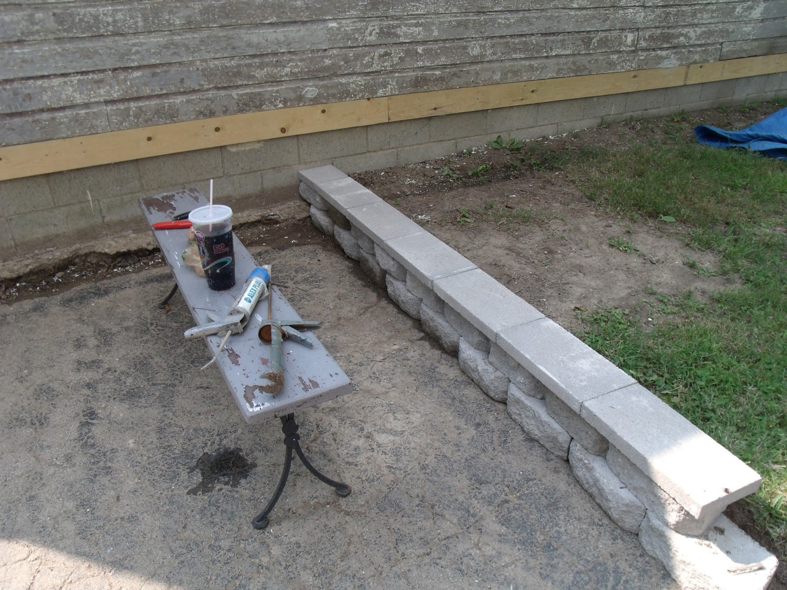 Gear Acres Installing the cap block on the retaining wall