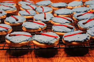 round sugar cookies with blue frosting and red light saber on top