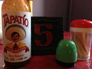 Hot sauce, salt, pepper and table numbers at Vego and Love'n It, Adelaide
