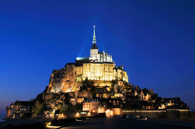 Welcome to our tour of Normandy, France. Mont Saint-Michel glows like a beacon on the edge of the sea. Photo: WikiMedia.org.