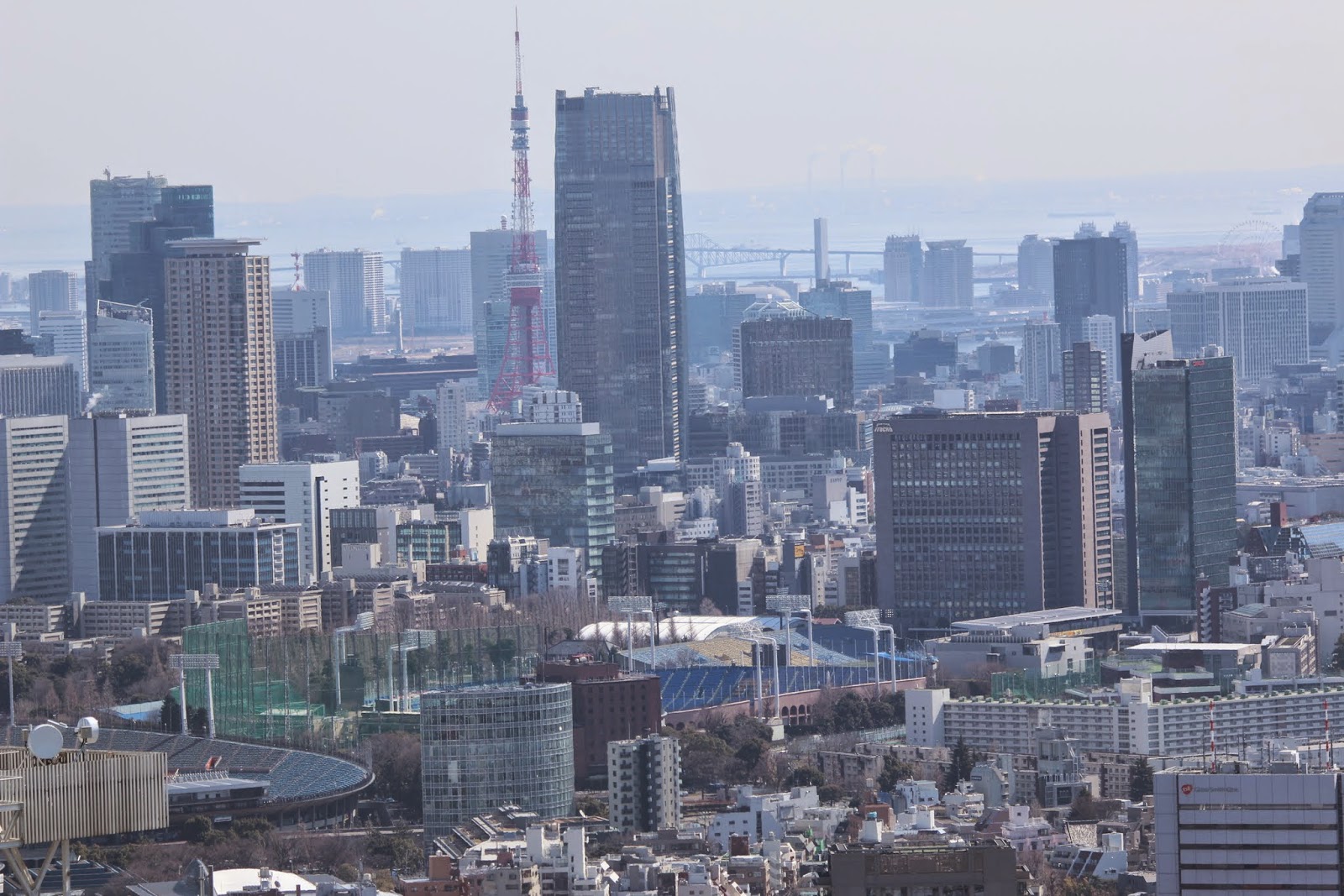 Tokyo Tower can be seen at the observation deck of Tokyo Metropolitan Government Building in Shinjuku Business District of Tokyo, Japan Tokyo Tower can be seen at the observation deck of Tokyo Metropolitan Government Building in Shinjuku Business District of Tokyo, Japan