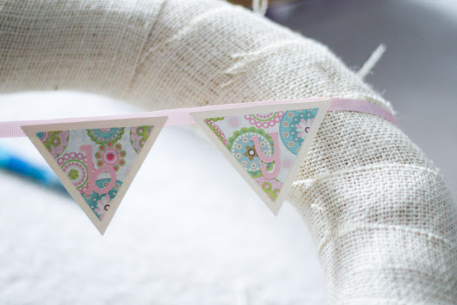 Put a pennant on a burlap wreath.  Sweet!