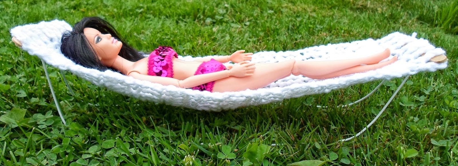 http://happierthanapiginmud.blogspot.com/2014/08/barbie-hammock-from-hanger-popsicle.html