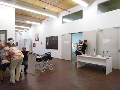 a large studio space with a baby carriage in it