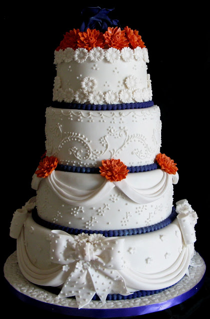 This cake was made for a bride whose wedding theme of orange purple and 