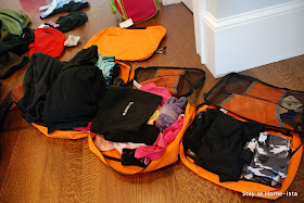 Packing ski clothes into packing cubes to keep everything organized