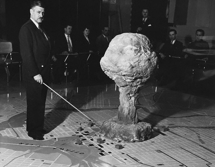 40 Amazing Historical Pictures - The commandant of the Civil Defense Technical Training Centre in Quebec demonstrates the effect of an atomic bomb exploding over a city 40 Amazing Historical Pictures - The commandant of the Civil Defense Technical Training Centre in Quebec demonstrates the effect of an atomic bomb exploding over a city