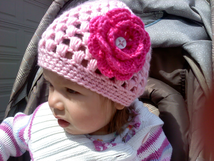 Pink hat. Button on a flower of your choice.