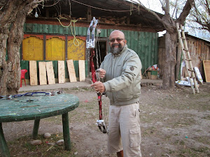 Self holding a "Hunting Bow".