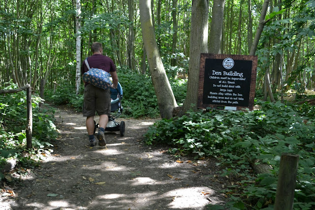 's Farm Mr Tin Box walking past a sign saying 'Den Building'