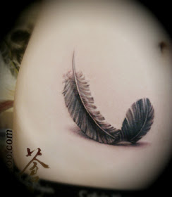 feather tattoo on the hip