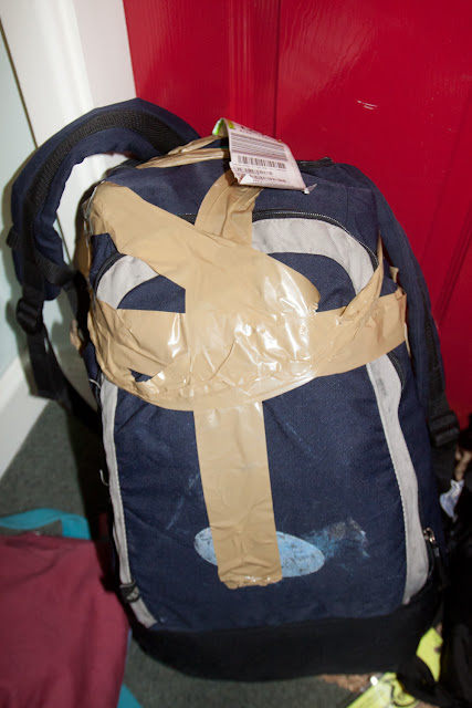 a blue backpack with tape on it