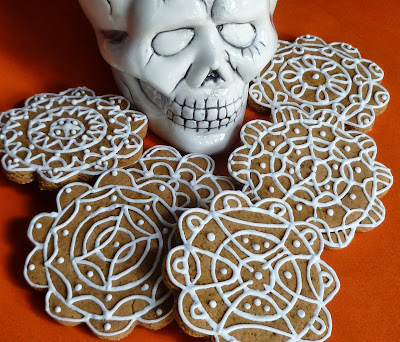 skull with uniquely decorated gingerbread cookies on orange
