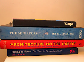 Four miniature-related books in a pile.