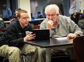 Founder of the Air Force photojournalism program Ken Hackman, right, offers advice during the Visual Media Workshop in Arlington, Va.