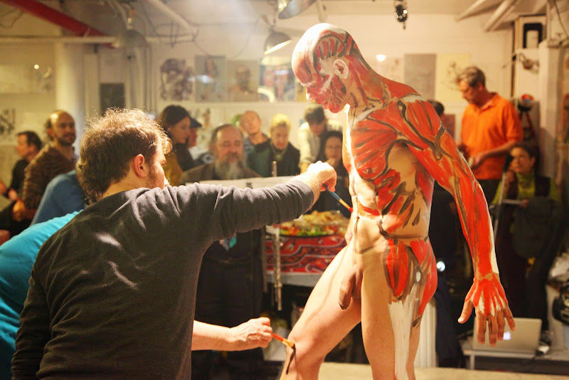 File:Man receiving body paint.   Wikimedia Commons