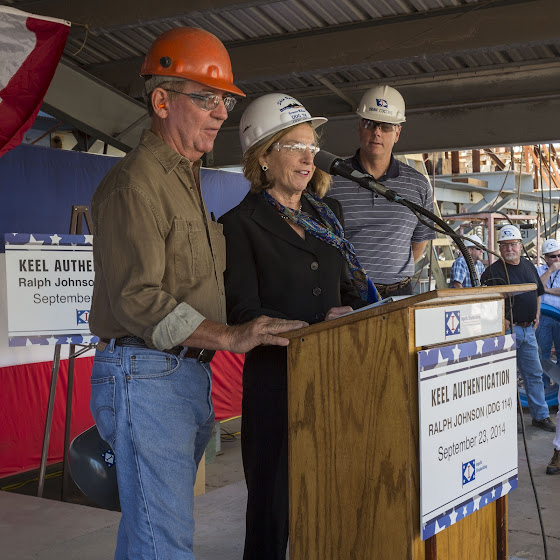 With Ingalls Shipbuilding President Brian Cuccias (right) observing, shipfitter Bob Boegner (left) and Ship Sponsor Georgeann McRaven delcare the keel of Ralph Johnson (DDG 114) to be ''truly and fairly laid.'' Photo by Lance Davis/HII Keel authentication DDG 114