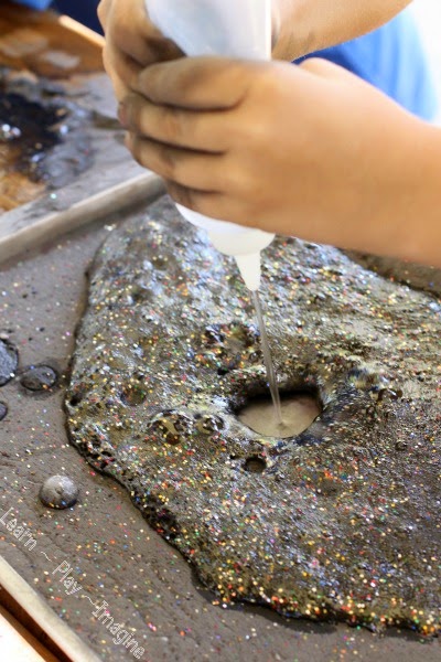 Erupting moon dust sensory tray - a prewriting activity that pops, fizzes, and bubbles!
