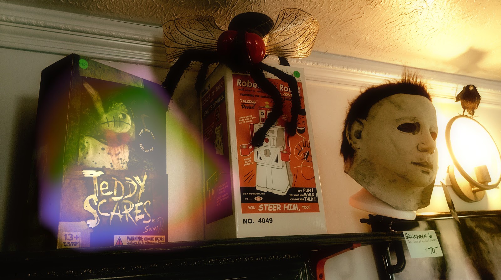 Mike Myers sits comfortably next to toy robots and giant flies