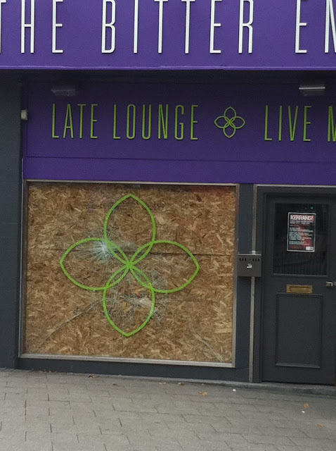 a store front with a purple sign and a purple sign