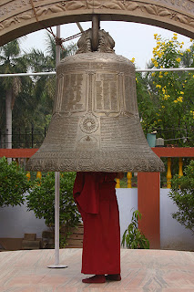 person standing under a bell