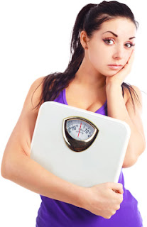 Young woman holding a scale