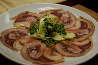 The final plate: sliced bath chaps with peppergrass, apples, and pumpkin seeds, all dressed with a cider and pumpkin oil vinaigrette