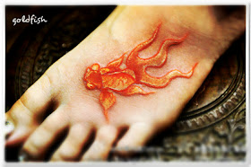 relief style goldfish tattoo on the foot with vivid color