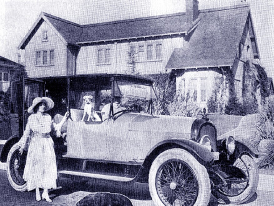 Mildred Chaplin (Charle's wife) at car after returning home from having a baby at the hospital.