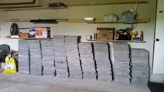 lots of bricks piled up in our garage for the patio