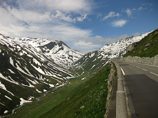 Road and snow-streaked mountains approaching the Furkapass from the east, Switzerland