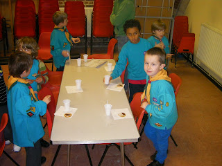 beaver scouts icing biscuits with chocolate buttons