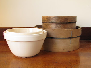 T.G. Green and Mason Cash pudding bowls or pudding basins stacked together with a vintage wooden sieve