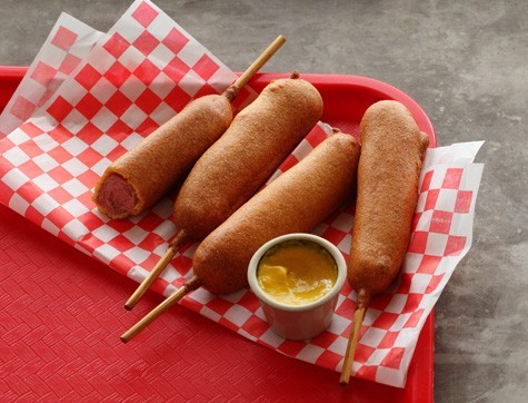 girl eating corn dog girl eating corn dog
