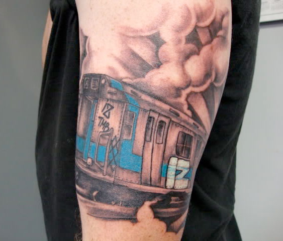 Above This tattoo shows a train bearing graffiti art graffiti tattoo