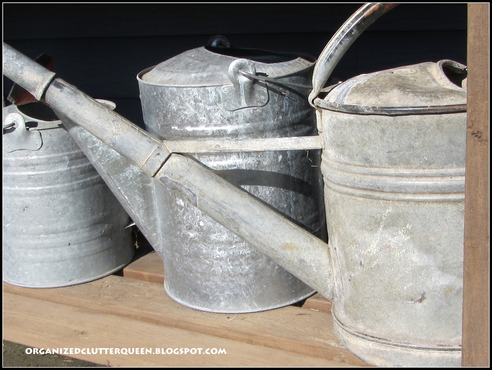 Potting Bench, Whiskey Barrels, and Hanging Pails Organized Clutter