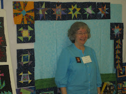 Terry smiles as she creates another story quilt!